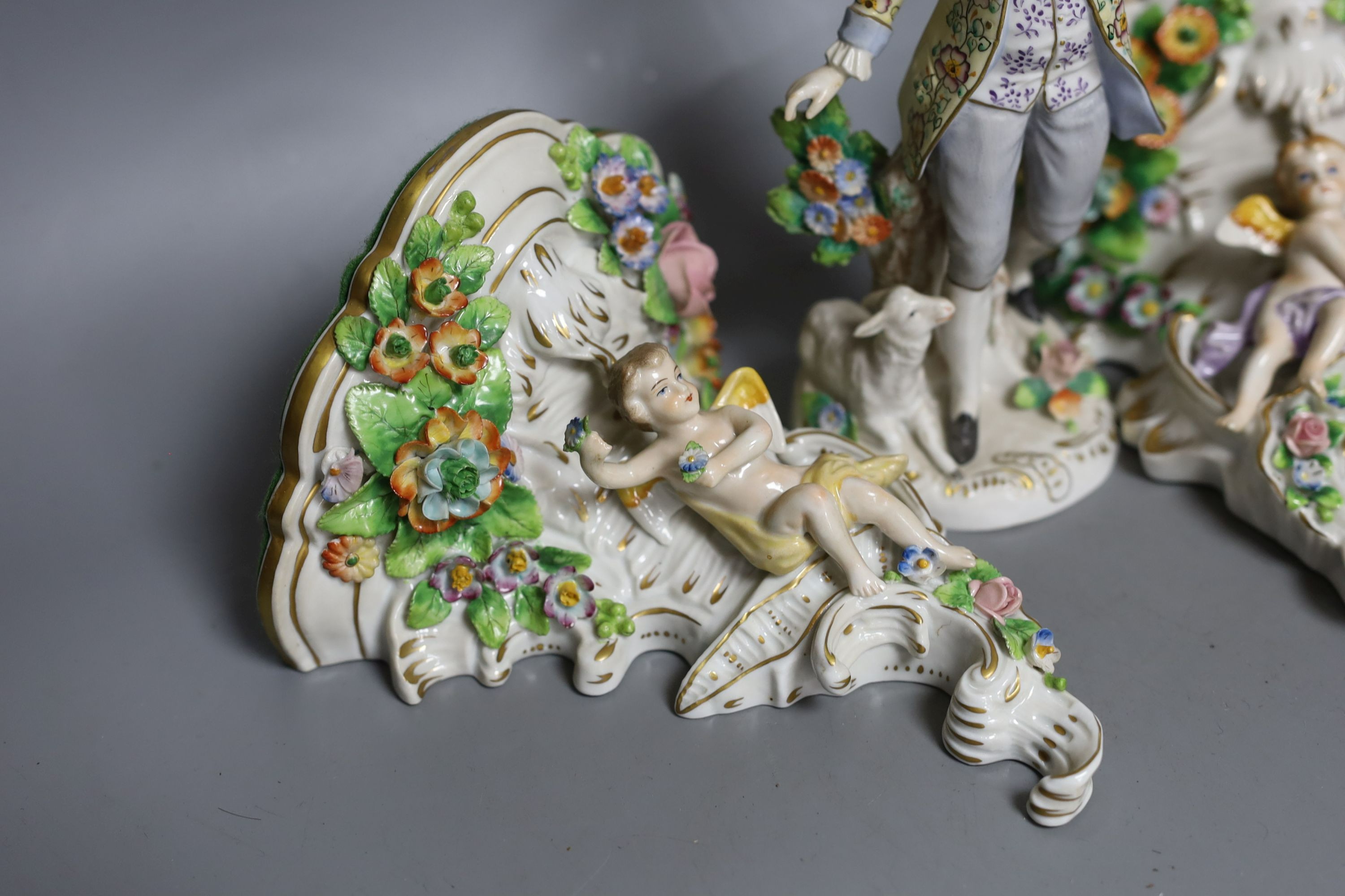 A pair of Sitzendorf wall brackets, 16cm tall, together with a Sitzendorf figure (3)
